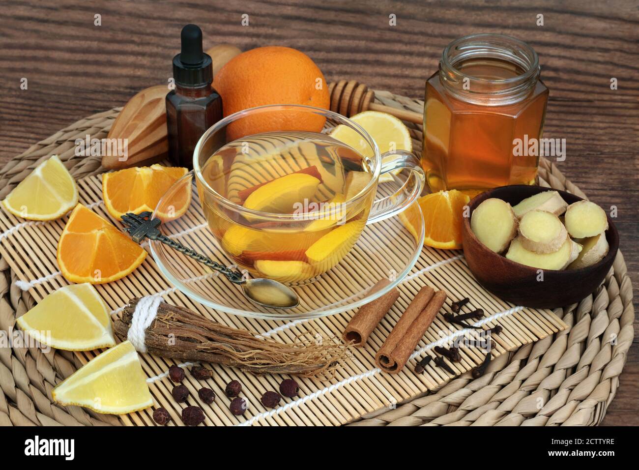 Natural healing herbal remedy for cold & flu virus with hot drink with fruit, herbs, honey, spices & essential oil. Stock Photo