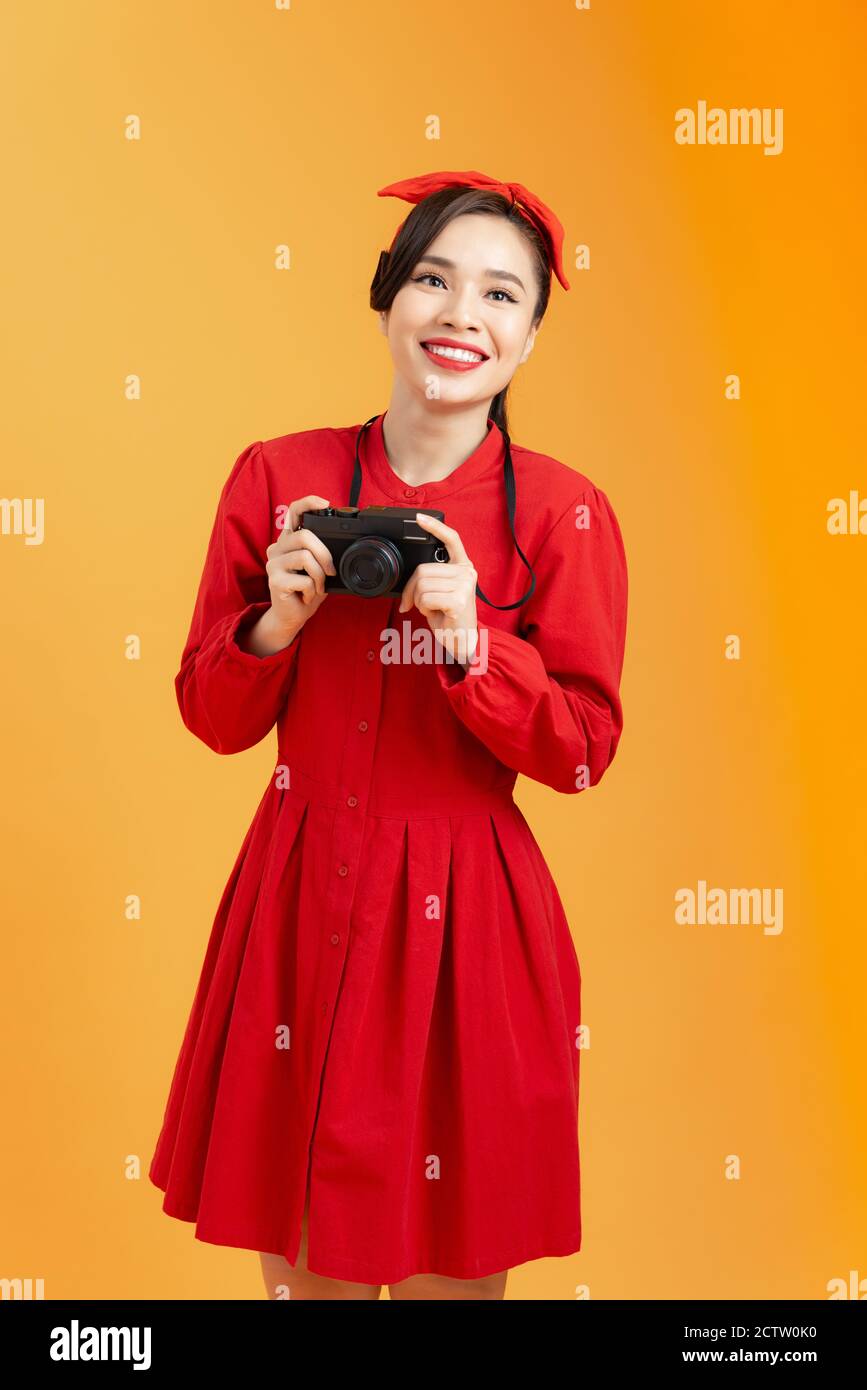 Expressive portrait of a beautiful young Asian woman in a red dress in ...