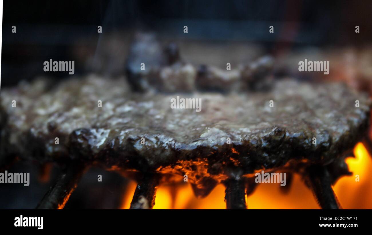 Burger on the Grill with Flames - Flame Grilled BBQ Stock Photo - Alamy