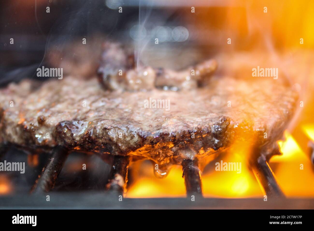 Burger on the Grill with Flames - Flame Grilled BBQ Stock Photo - Alamy