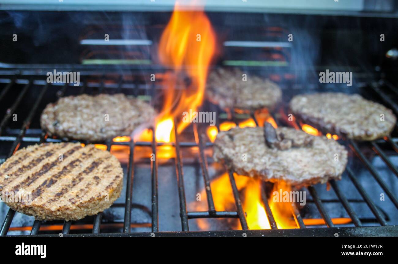 Burger on the Grill with Flames - Flame Grilled BBQ Stock Photo - Alamy