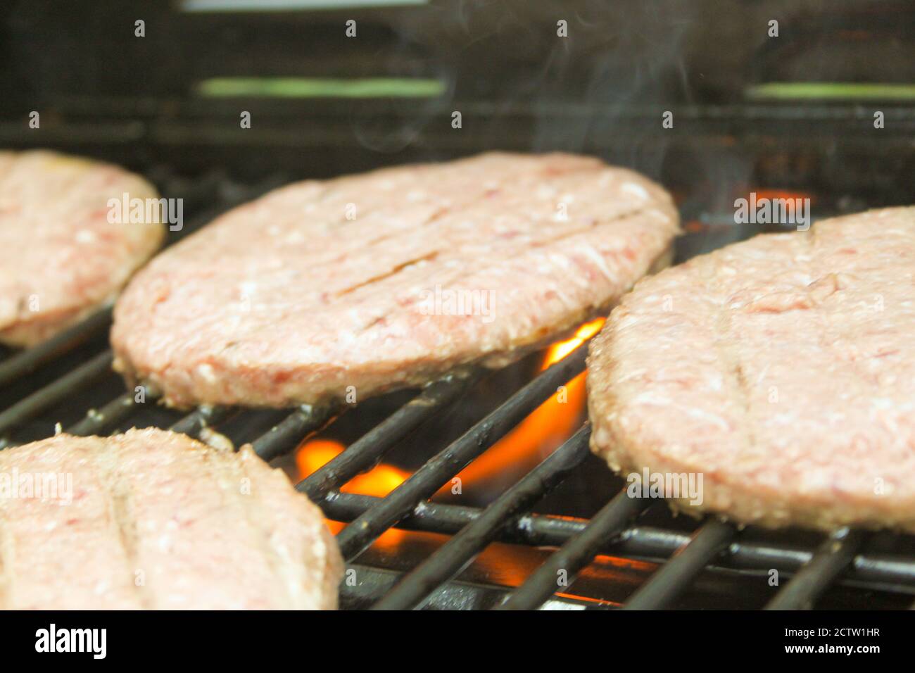 Burger on the Grill with Flames - Flame Grilled BBQ Stock Photo - Alamy
