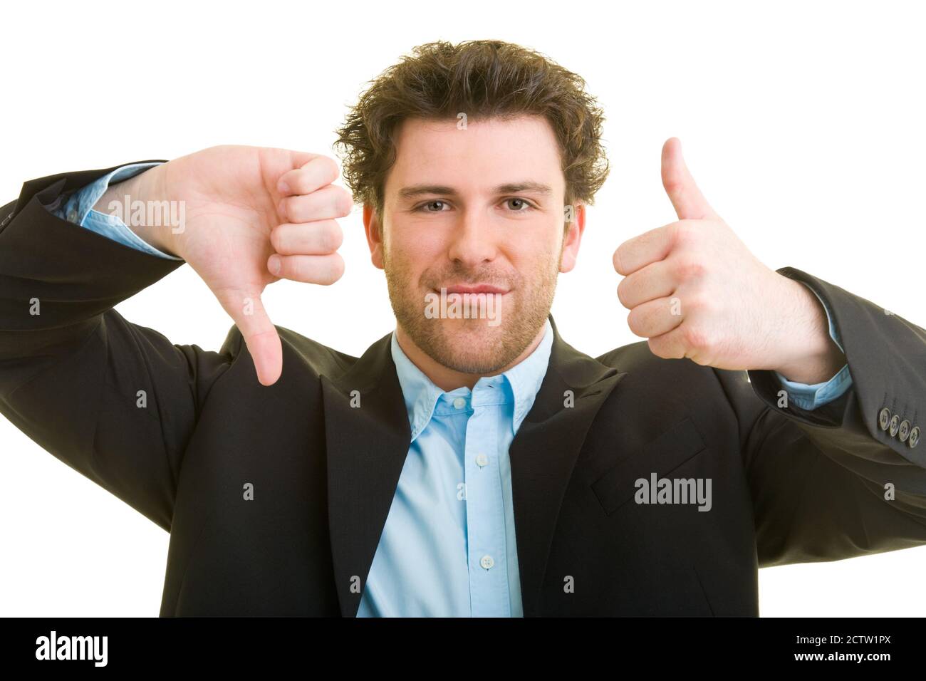 Young man in business attire shows one thumb up and the other down Stock Photo