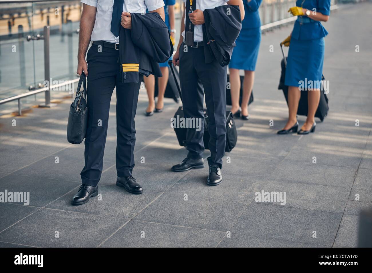 Pilots and flight attendants standing on the street Stock Photo