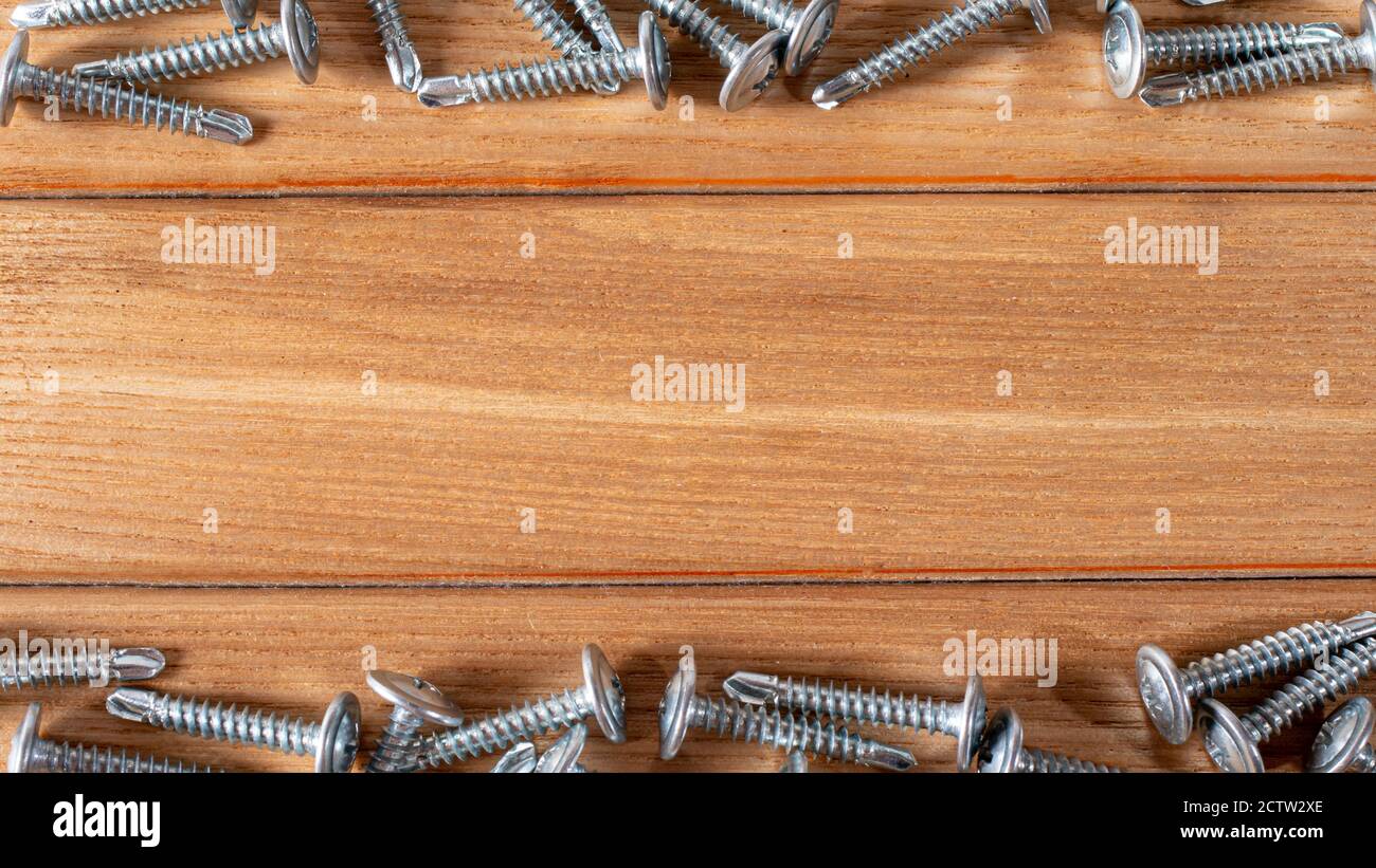 Self-cutters on a wooden background with space for text. Accessories and construction equipment. Banner for construction store and repair. Stock Photo