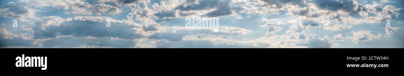 Panorama of blue sky with fluffy white clouds. Abstract background ...