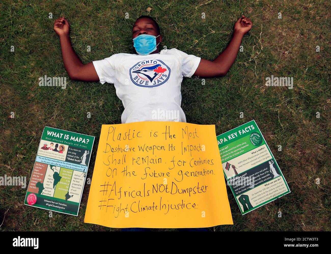 Kevin Mtai, a climate change and environmental activist, lays during a protest marking a global climate action day under the theme ''#AfricaIsNotADumpster'' at the Uhuru Park's Freedom Corner in Nairobi, Kenya, September 25, 2020. REUTERS/Thomas Mukoya Stock Photo