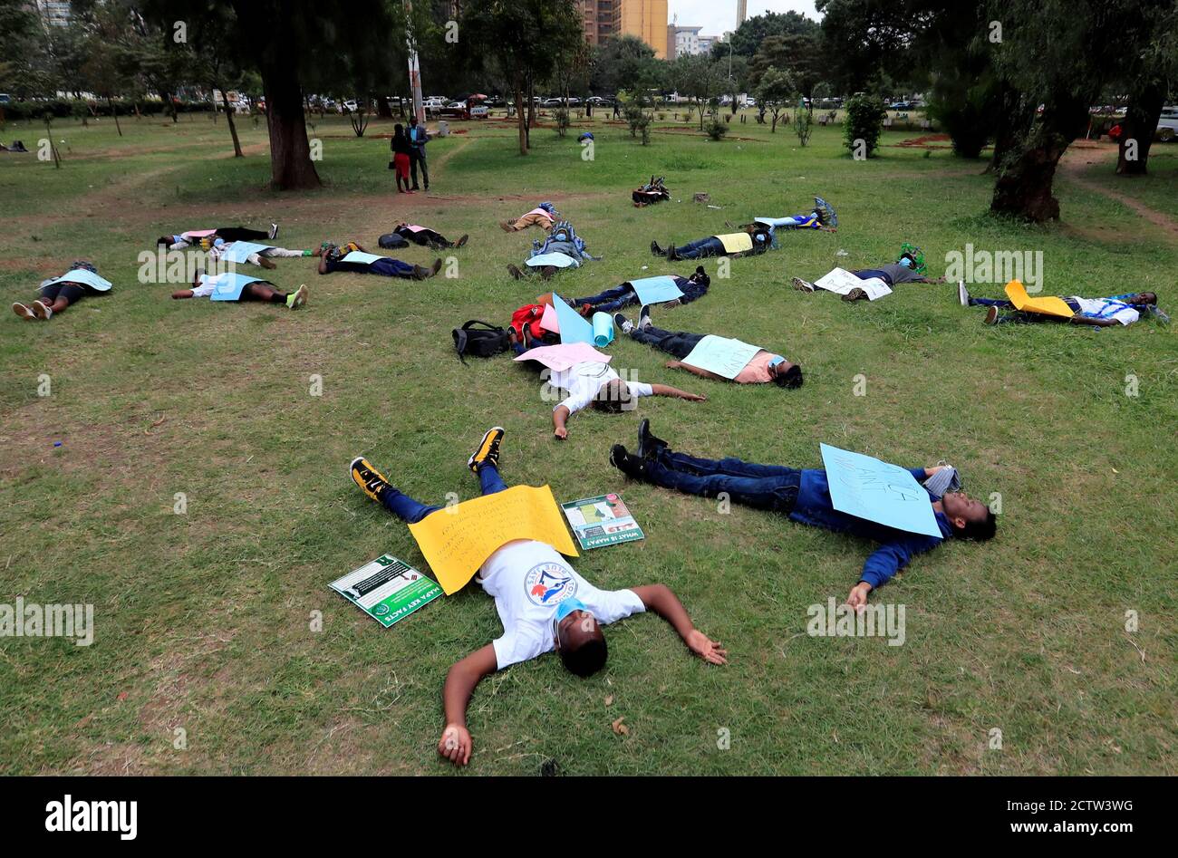 Climate change and environmental activists lay on the grass during a protest marking a global climate action day under the theme ''#AfricaIsNotADumpster'' at the Uhuru Park's Freedom Corner in Nairobi, Kenya, September 25, 2020. REUTERS/Thomas Mukoya Stock Photo