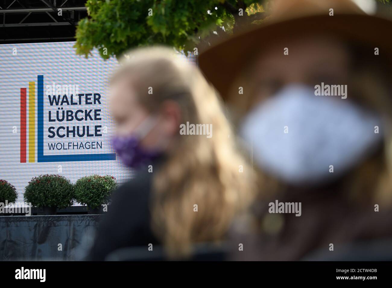 Wolfhagen, Germany. 25th Sep, 2020. Pupils sit in front of the new logo at the ceremony to mark the renaming of the Wilhelm Filchner School to Walter Lübcke School. Former Kassel district president Walter Lübcke was murdered on the terrace of his house in Wolfhagen-Istha on the night of 02.06.2019. Credit: Swen Pförtner/dpa/Alamy Live News Stock Photo