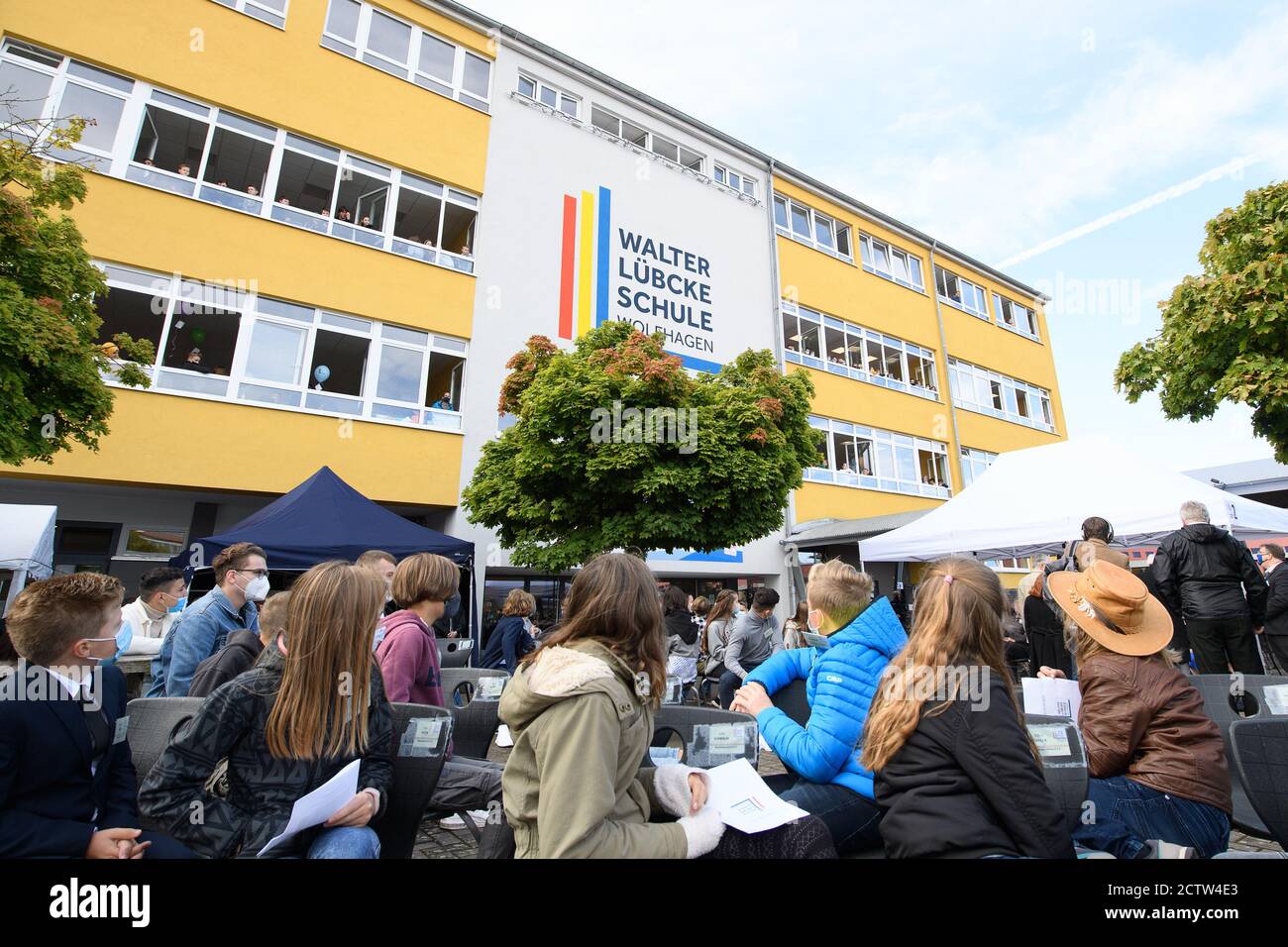 Wolfhagen, Germany. 25th Sep, 2020. Pupils sit in front of the new logo at the ceremony to mark the renaming of the Wilhelm Filchner School to Walter Lübcke School. Former Kassel district president Walter Lübcke was murdered on the terrace of his house in Wolfhagen-Istha on the night of 02.06.2019. Credit: Swen Pförtner/dpa/Alamy Live News Stock Photo