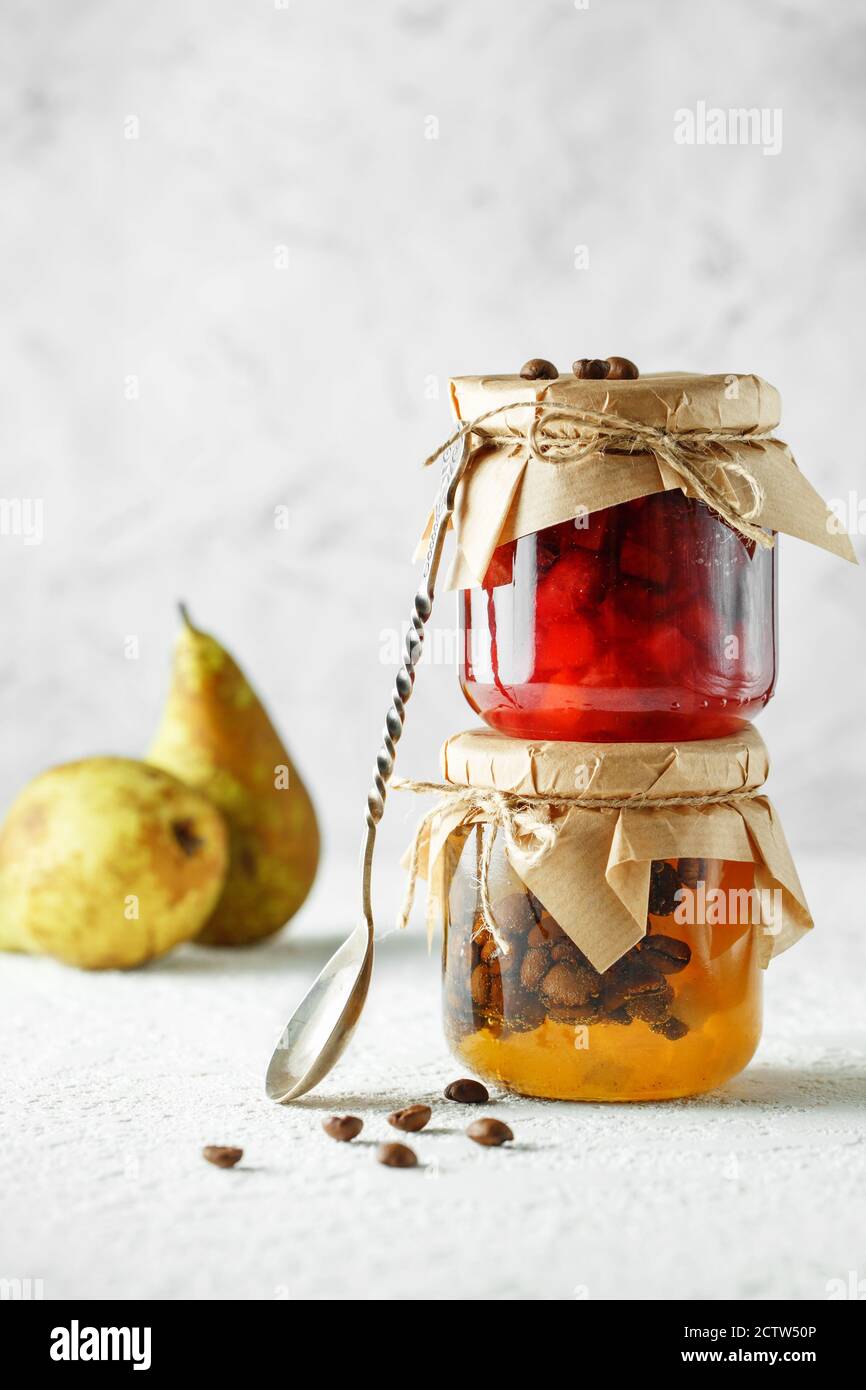 two jars of fruit homemade jam. pear marmalade with coffee beans and