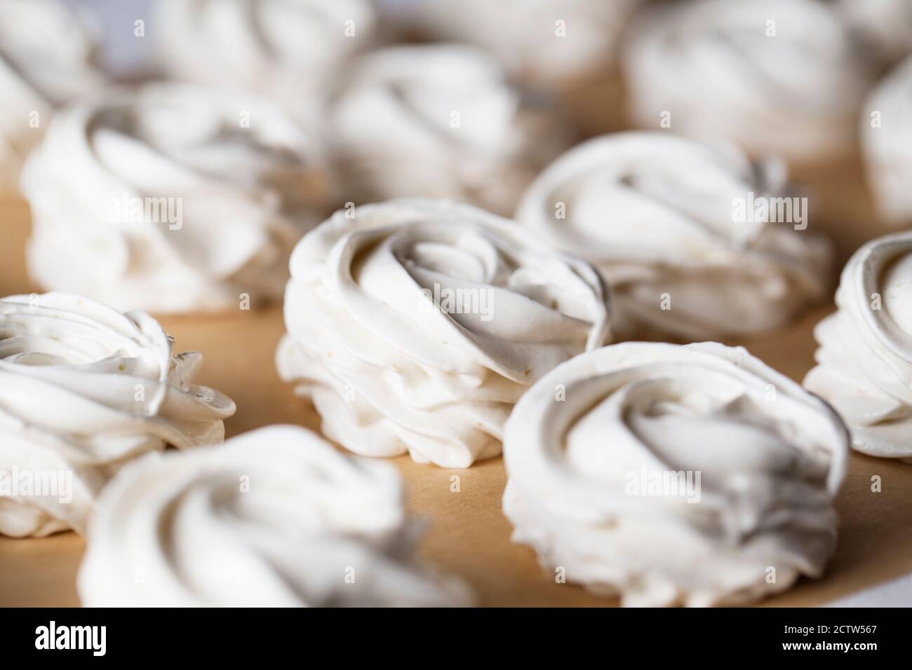 The process of making marshmallow. Close up hands of the chef with confectionery bag cream to