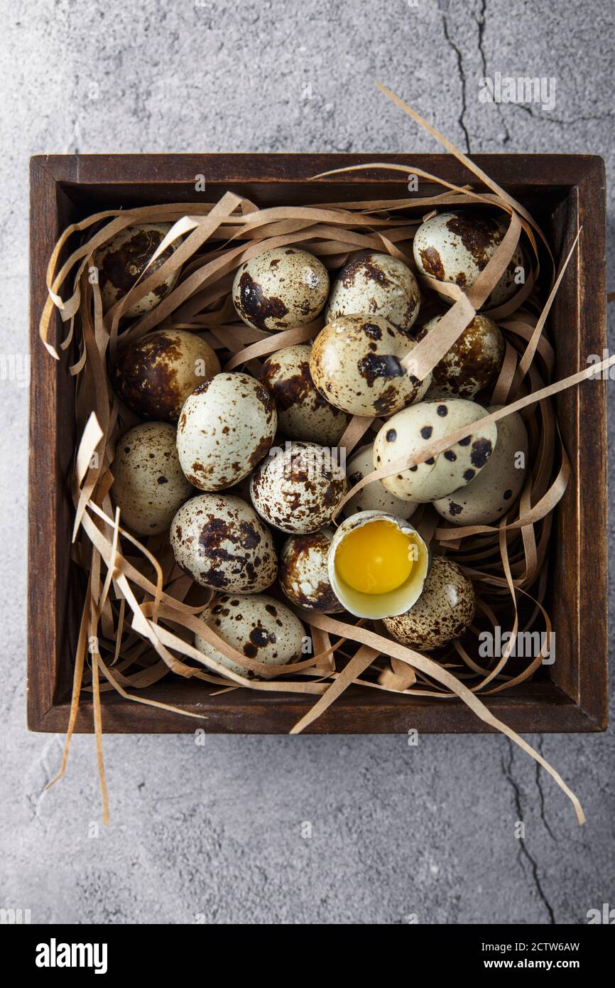 Quail eggs. Flat lay composition with small quail eggs in the wooden