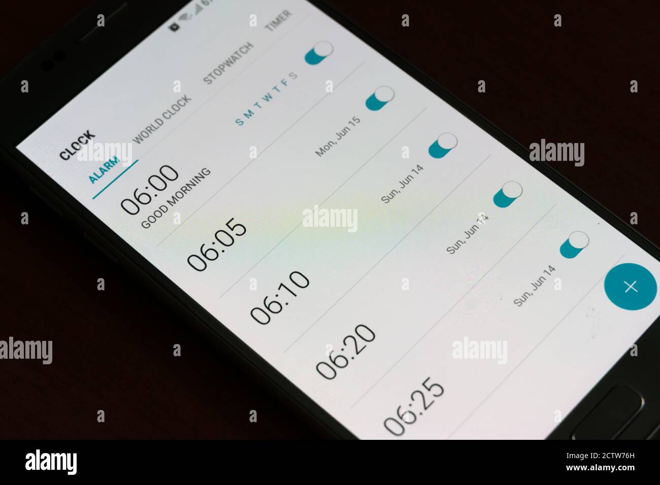 Smartphone screen with alarms turned on every five minutes closeup