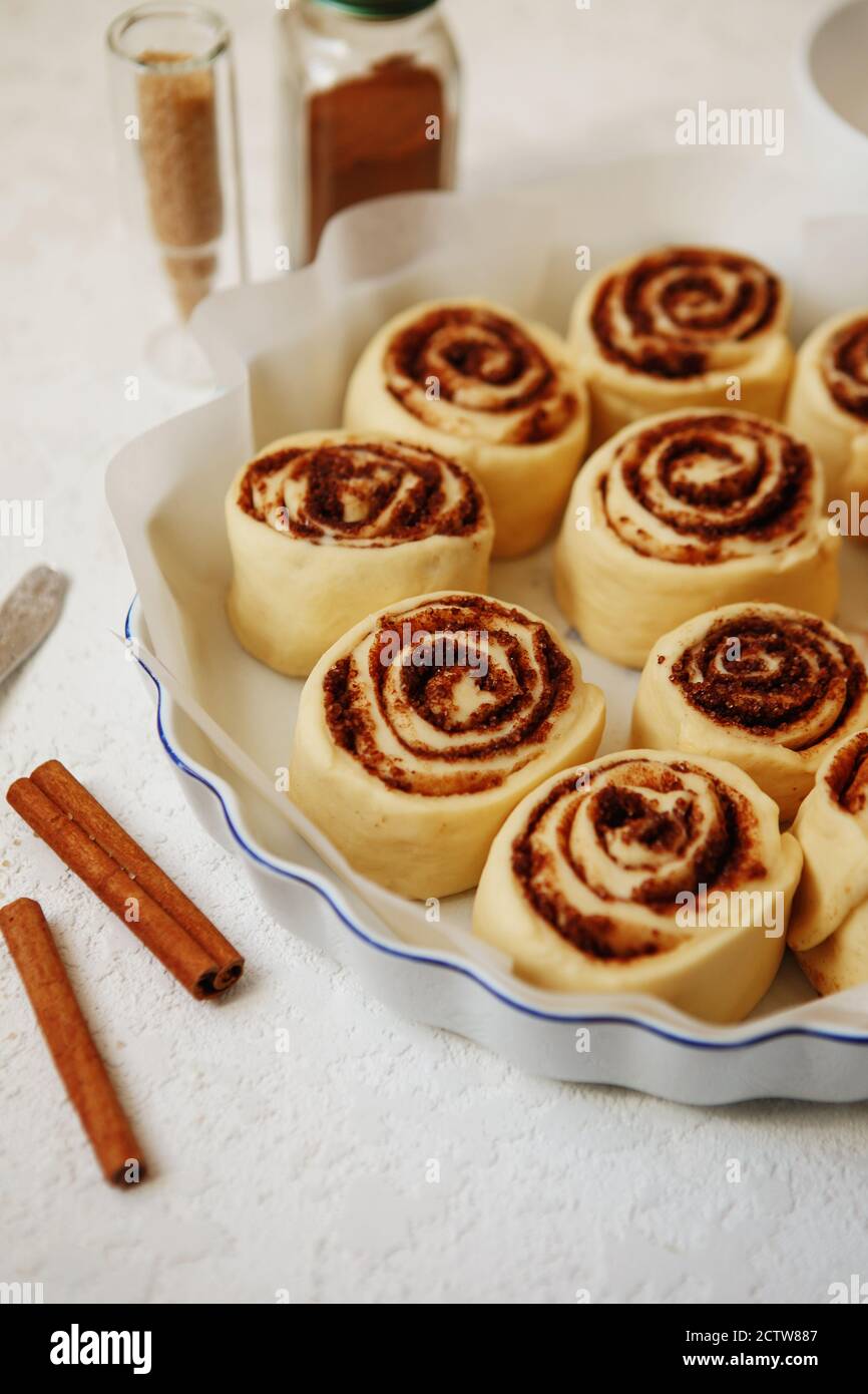 Cinnabon buns. Raw Cinnamon rolls in a baking dish before baking Stock Photo