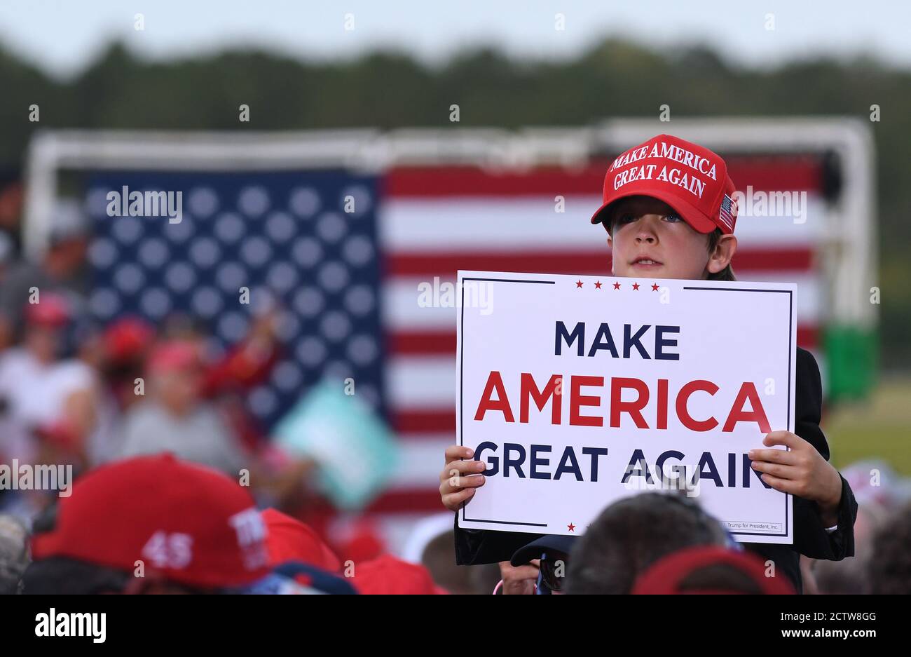 Jacksonville, United States. 24th Sep, 2020. A young boy wearing a Make America Great Again (MAGA) hat holds a MAGA placard while waiting for U.S. President Donald Trump to speak at a Great American Comeback campaign rally at Cecil Airport.With 40 days until the 2020 presidential election, recent polls show a tight race between Trump and his Democratic opponent, former U.S. Vice President Joe Biden. Credit: SOPA Images Limited/Alamy Live News Stock Photo