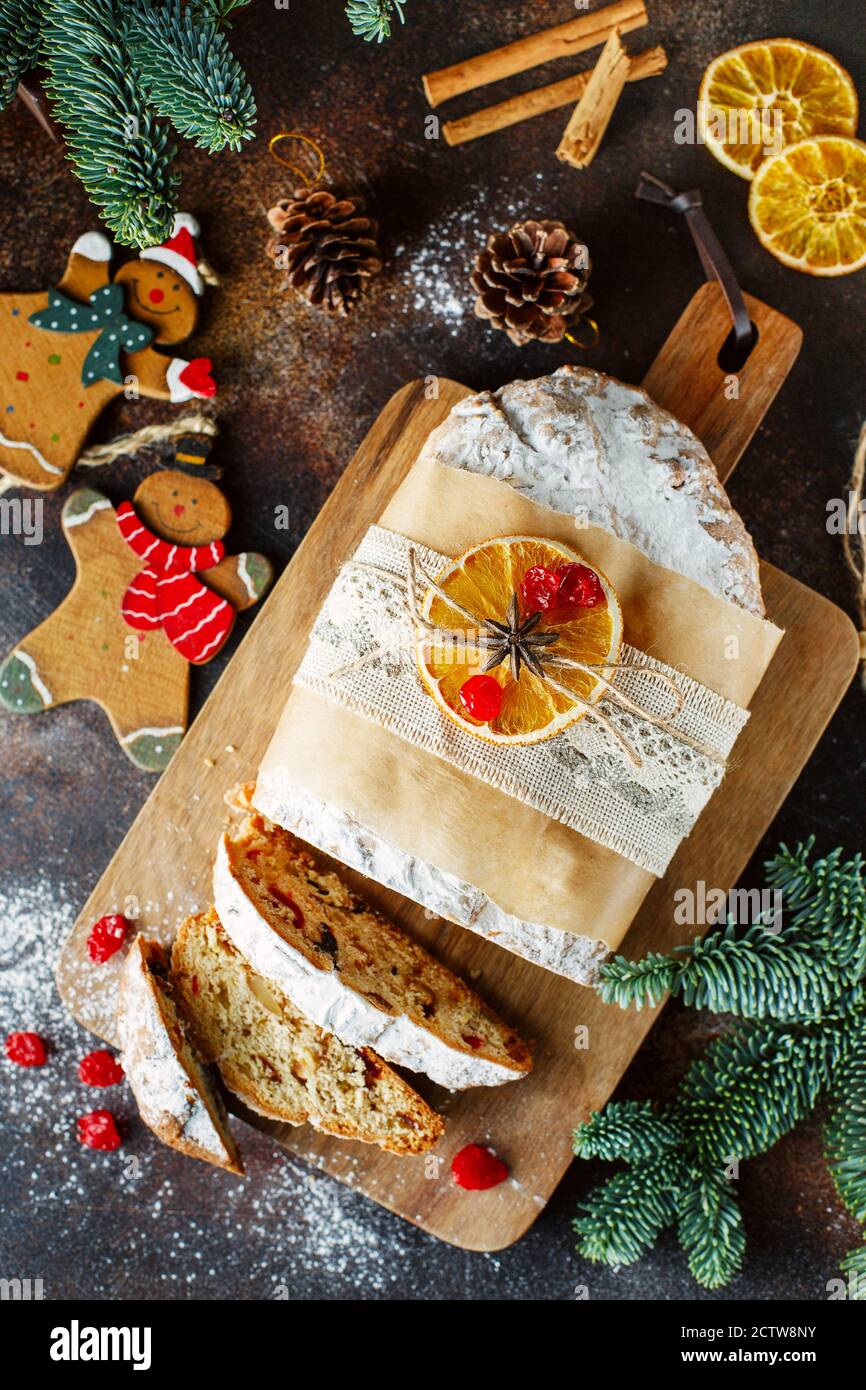 Holiday Baking Christmas Cake Flat Lay Composition Of Stollen Spruce Branches Christmas Tree Decorations Cones Dry Slices Of Oranges Berries An Stock Photo Alamy
