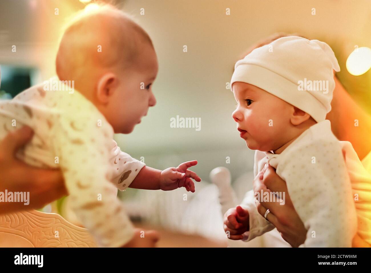 Two infant babies are very interested in each other. Learn Stock Photo ...