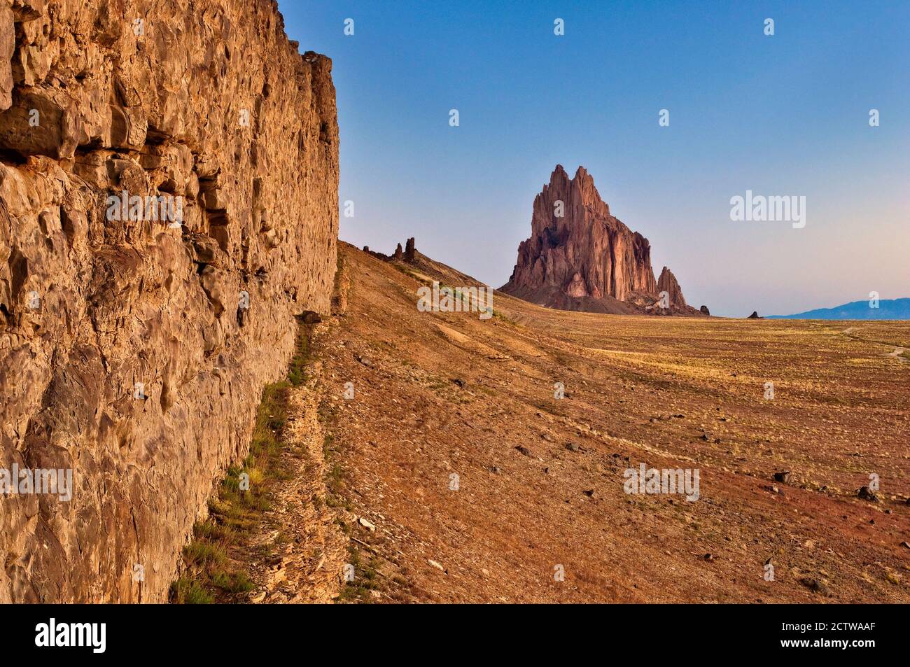Shiprock, sacred Navajo mountain, dike ridge on left, at sunrise, New Mexico, USA Stock Photo