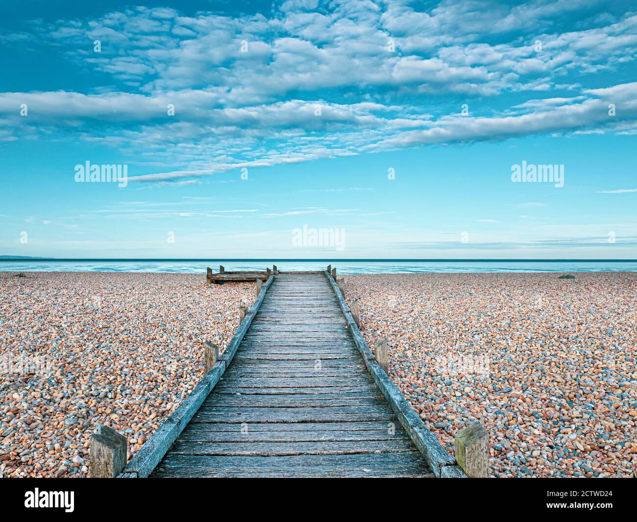 Dungeness beach with wooden footpath, Kent, UK Stock Photo