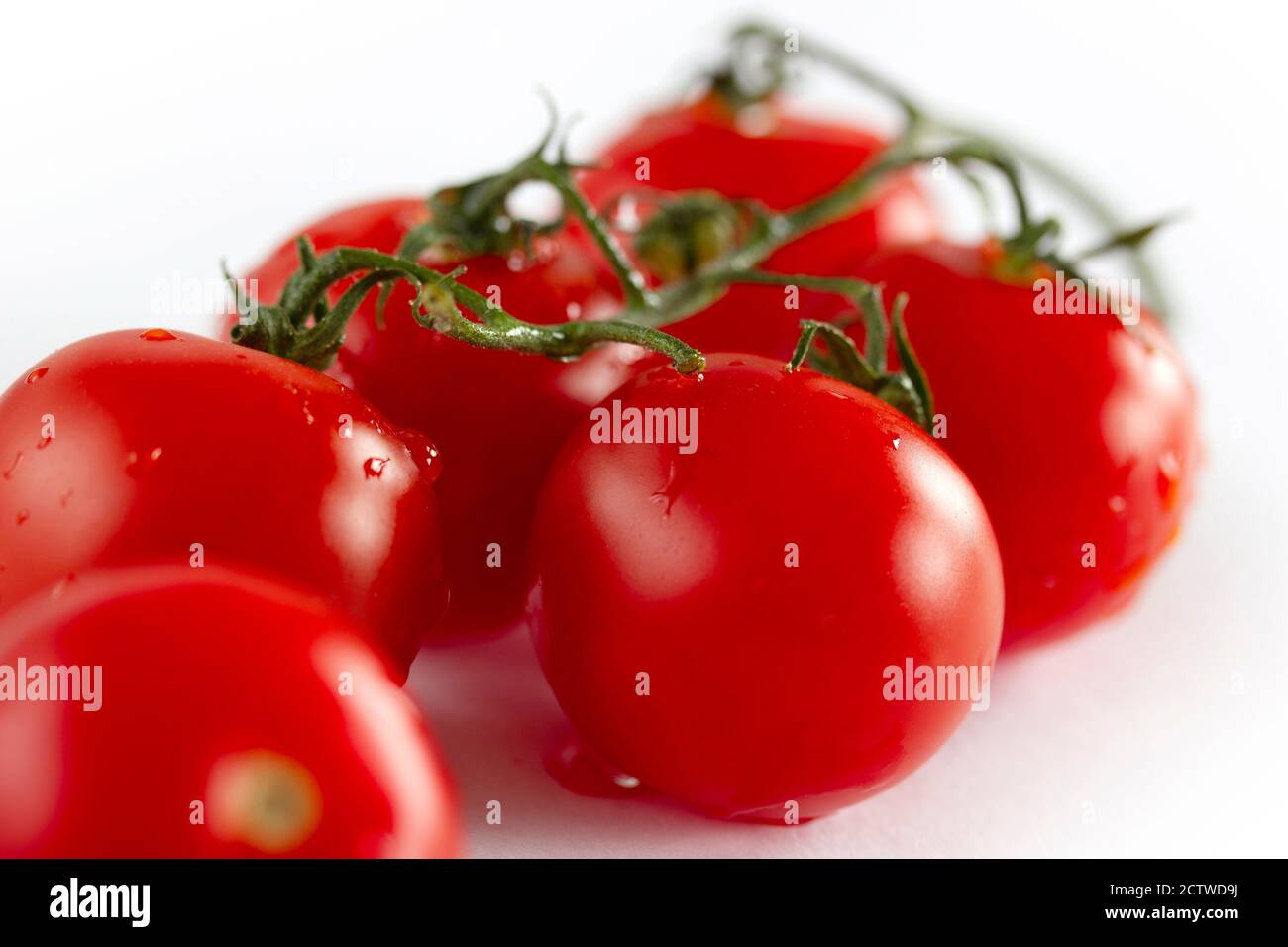cherry tomatoes on a white background Stock Photo - Alamy