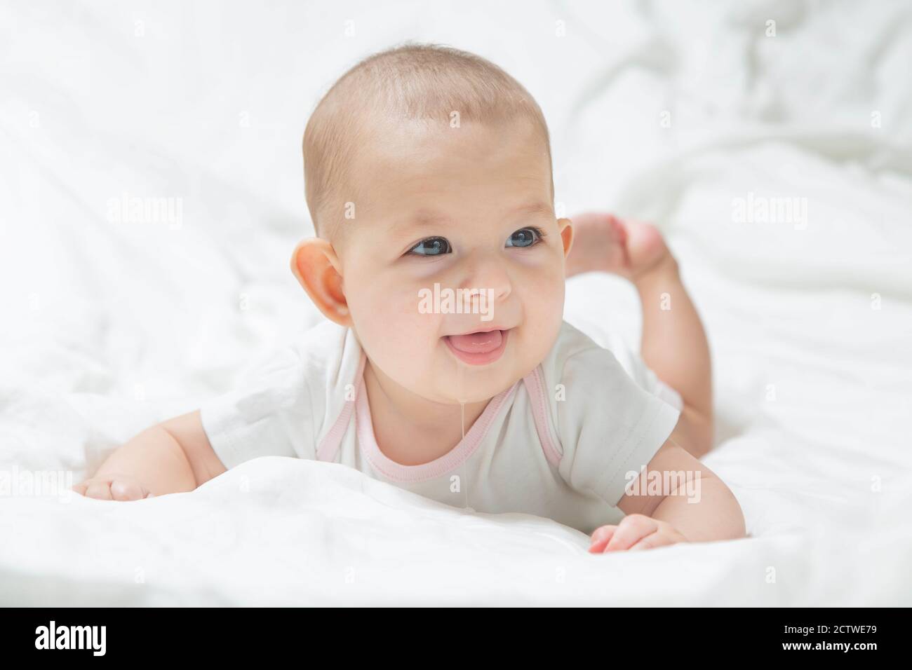 Increased salivation in the infant during teething. A baby girl in