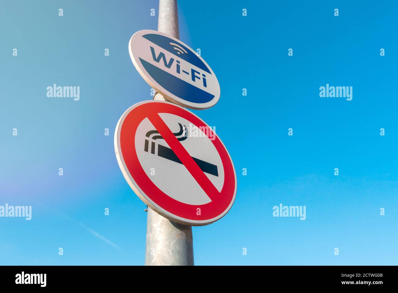 Pole with signs of Wireless Internet Hotspot and Smoke-Free zone Stock Photo