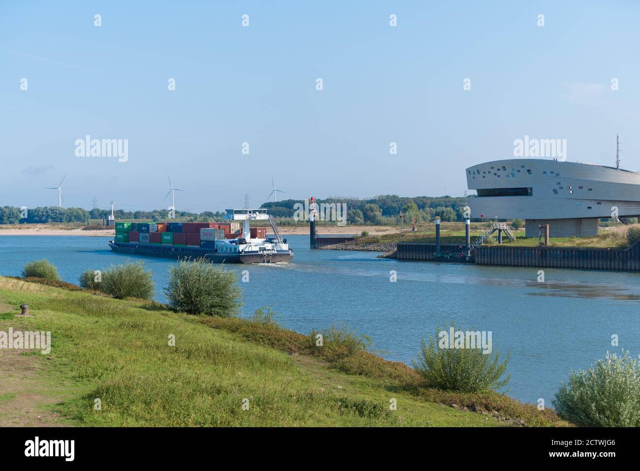 NIJMEGEN, NETHERLANDS - SEPTEMBER 12, 2020: container ship on the Maas-Waal canal at the water traffic control point Nijmegen Stock Photo