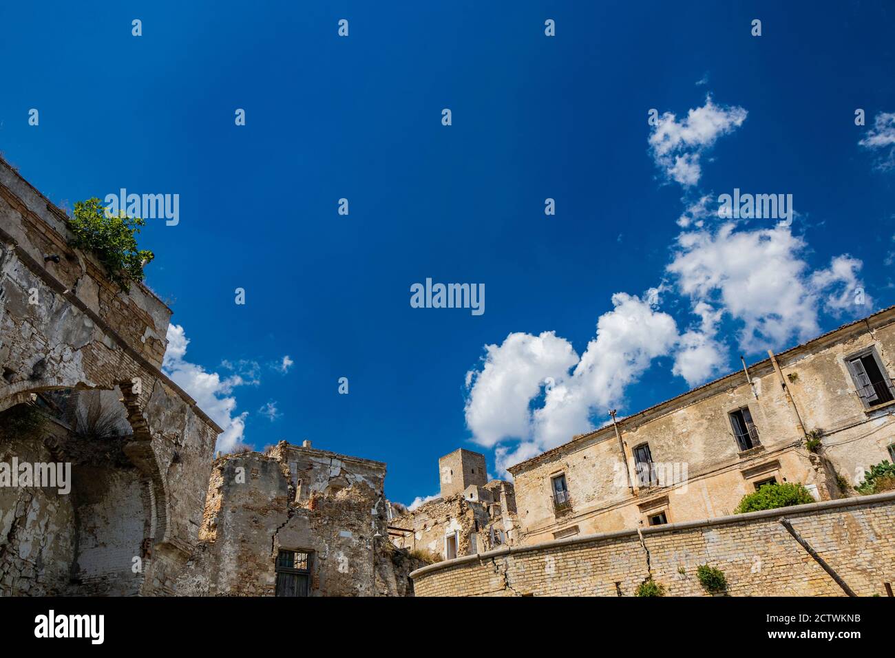 Craco, Matera, Basilicata, Italy. The ghost town destroyed and abandoned following a landslide. The collapsed houses and the remains invaded by vegeta Stock Photo