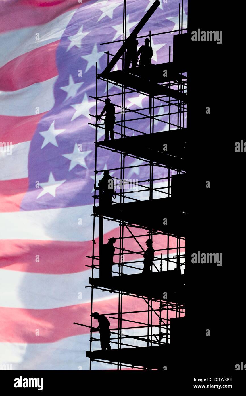 Construction workers on scaffolding with Stars and Stripes flag as backdrop. Concept image: USA, American economy, blue collar worker... Stock Photo