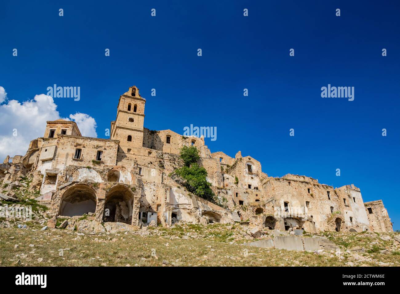 Craco, Basilicata, Italy. Ghost town destroyed and abandoned following a landslide. Collapsed houses and the remains invaded by vegetation. Broken wal Stock Photo