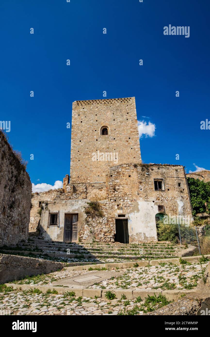 Craco, Matera, Basilicata, Italy. The ghost town destroyed by a landslide. The collapsed houses and the remains invaded by vegetation. The ancient wat Stock Photo