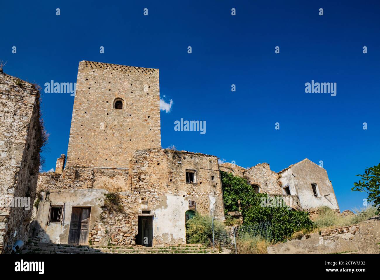 Craco, Matera, Basilicata, Italy. The ghost town destroyed by a landslide. The collapsed houses and the remains invaded by vegetation. The ancient wat Stock Photo