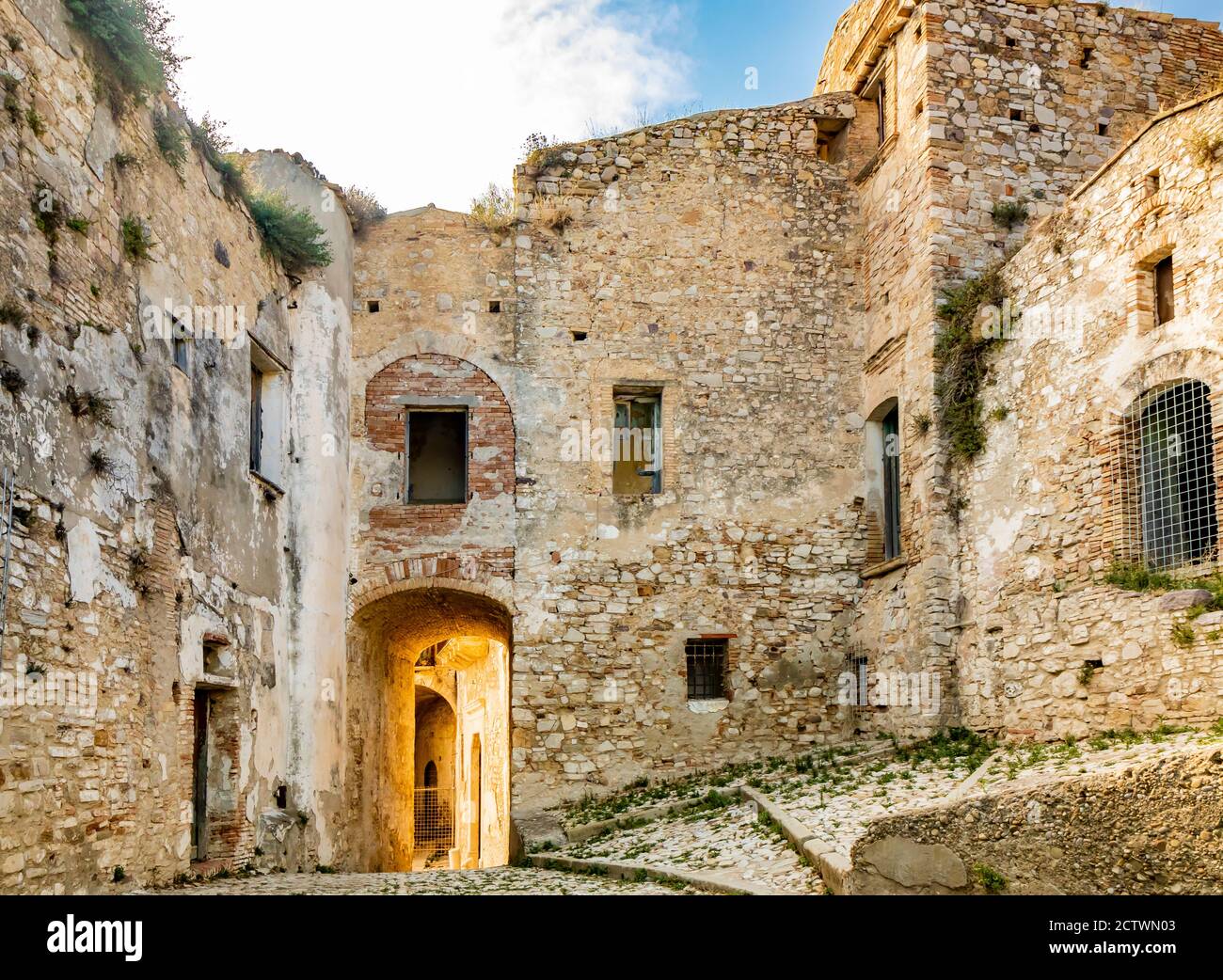Craco, Matera, Basilicata, Italy. The ghost town destroyed and abandoned following a landslide. The collapsed houses and the remains invaded by vegeta Stock Photo