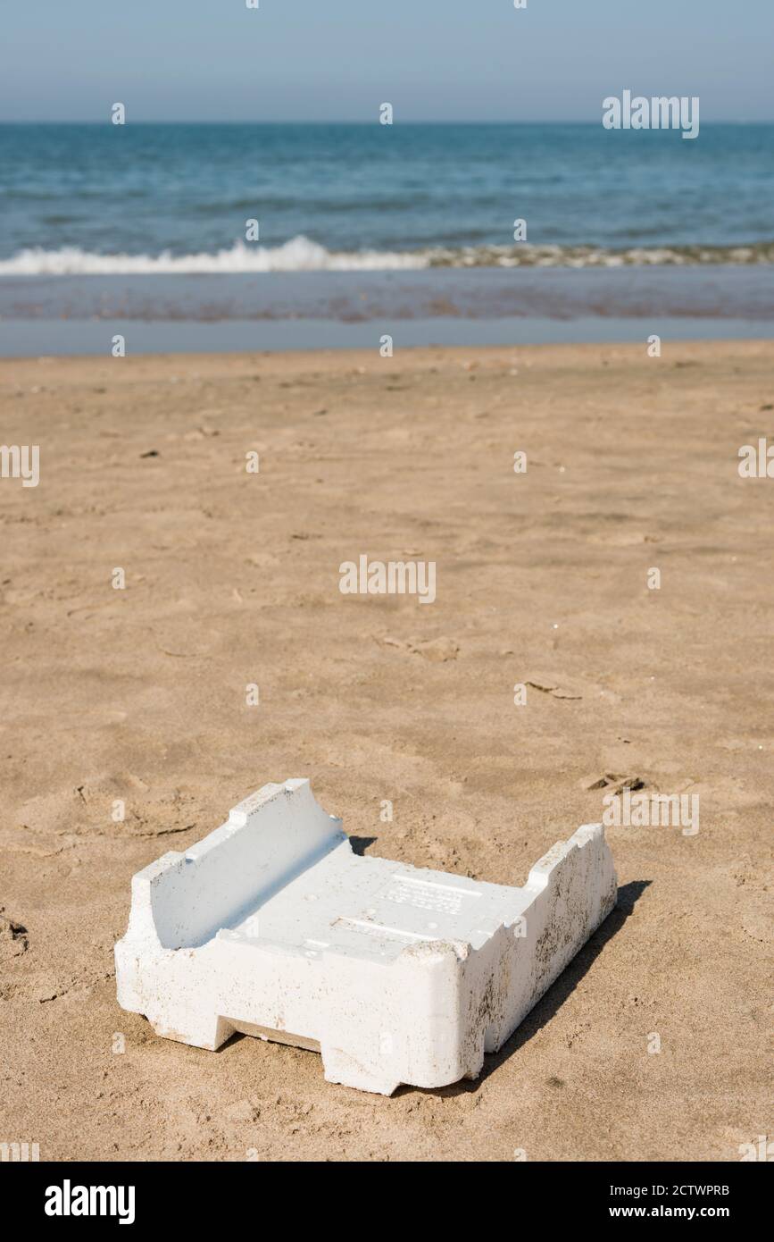 Plastic, white, styrofoam container left on sandy beach. Stock Photo