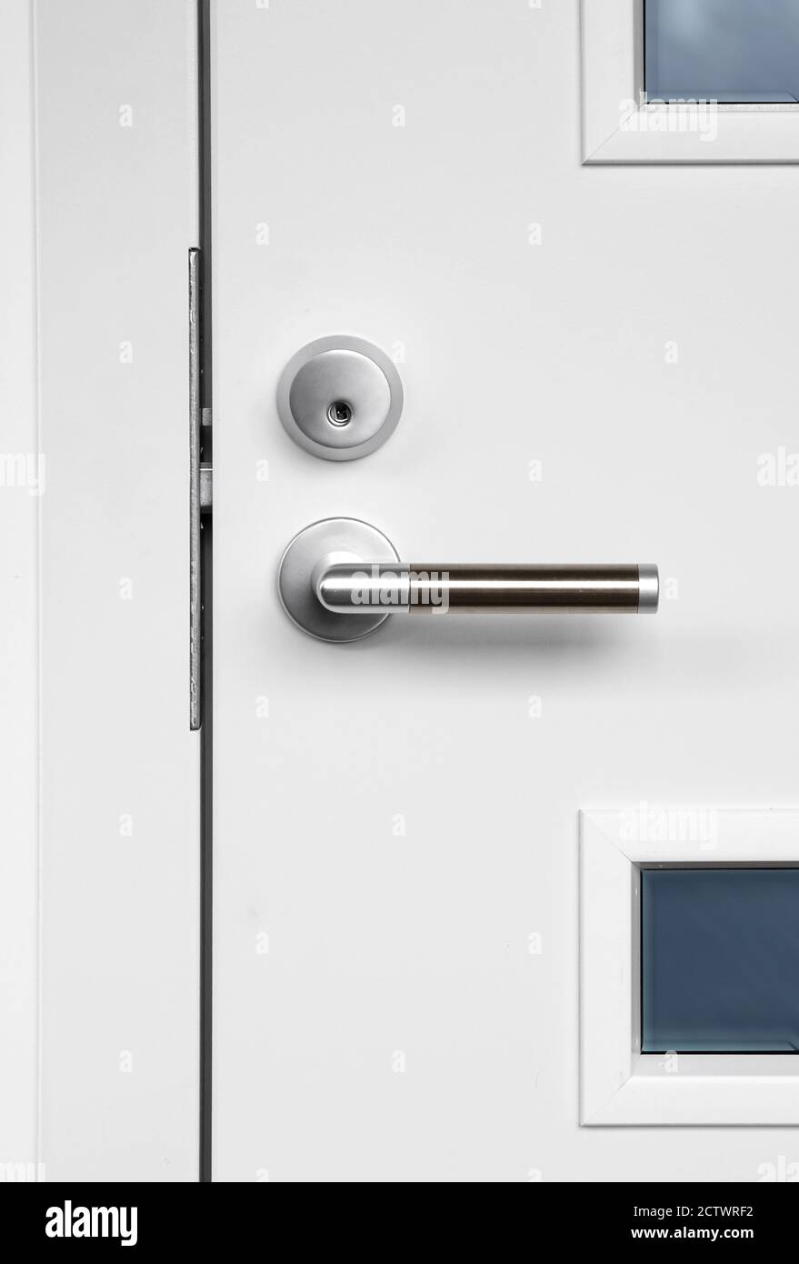 Modern white front door with metal fixture handle and lock Stock Photo ...