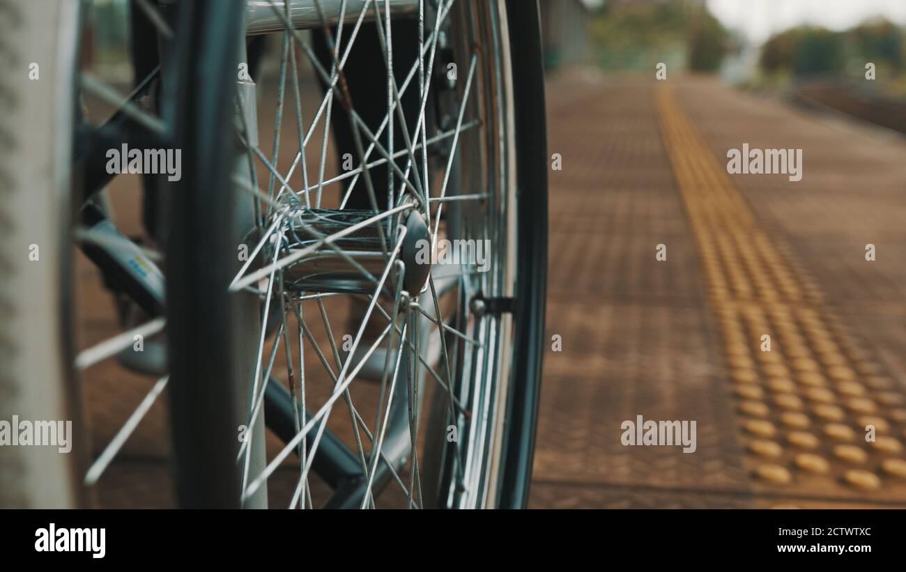 Low Angle Close Up Of The Wheels Of The Wheelchair On The Train 