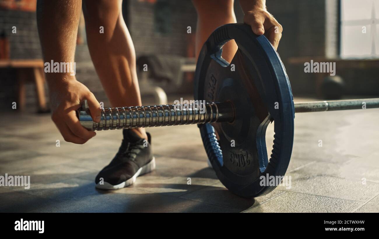 Close-up Shot of Bodybuilder Puts Additional Weights on a Barbell ...