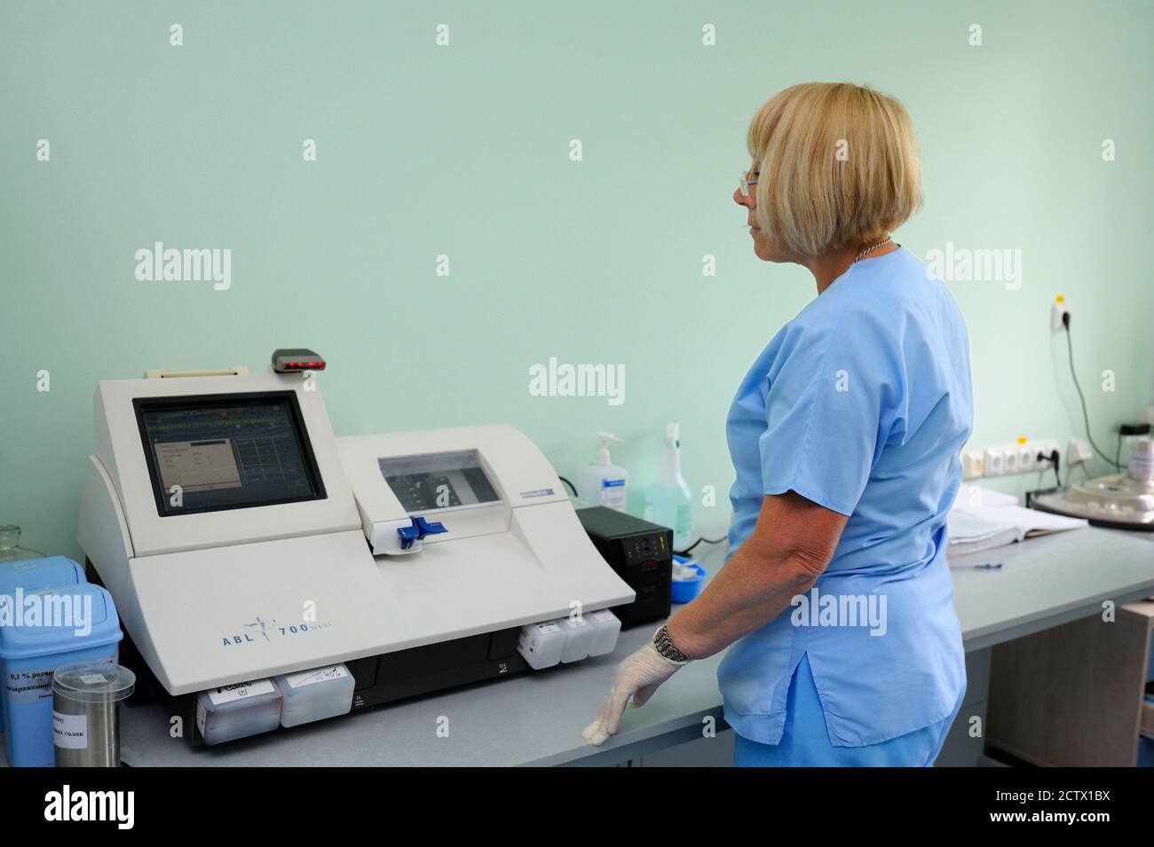 At a hospital laboratory. Lab technician taking test results of blood