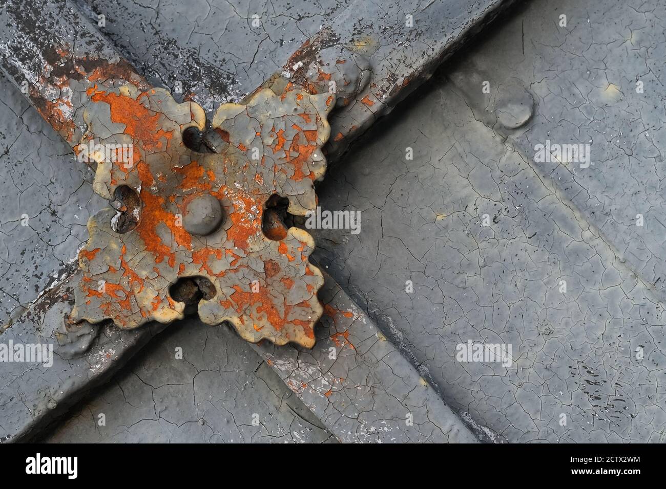 Fragment of ancient peeling and decayed monastery gates with rusty skillfully forged decorative overlay.  Stock Photo
