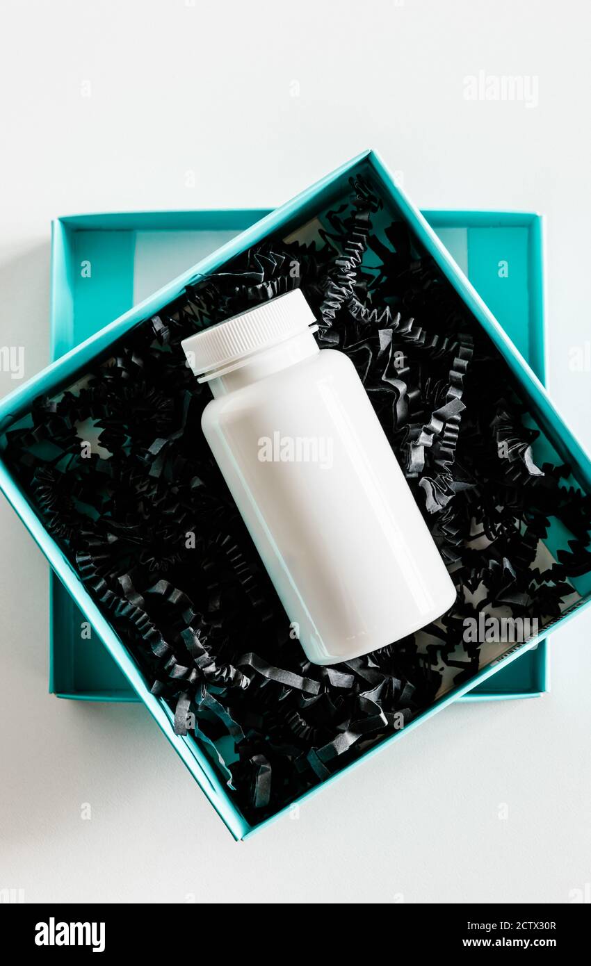 Pill bottle in gift box. Stock Photo