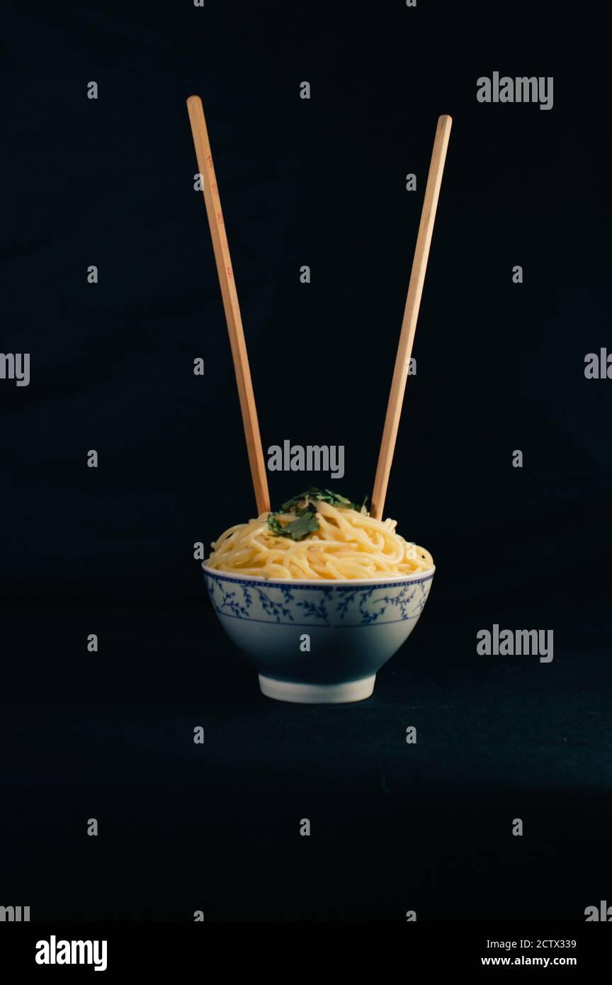 Spaghetti bowl with Asian Noodles stuck in it. Vertical photo Stock