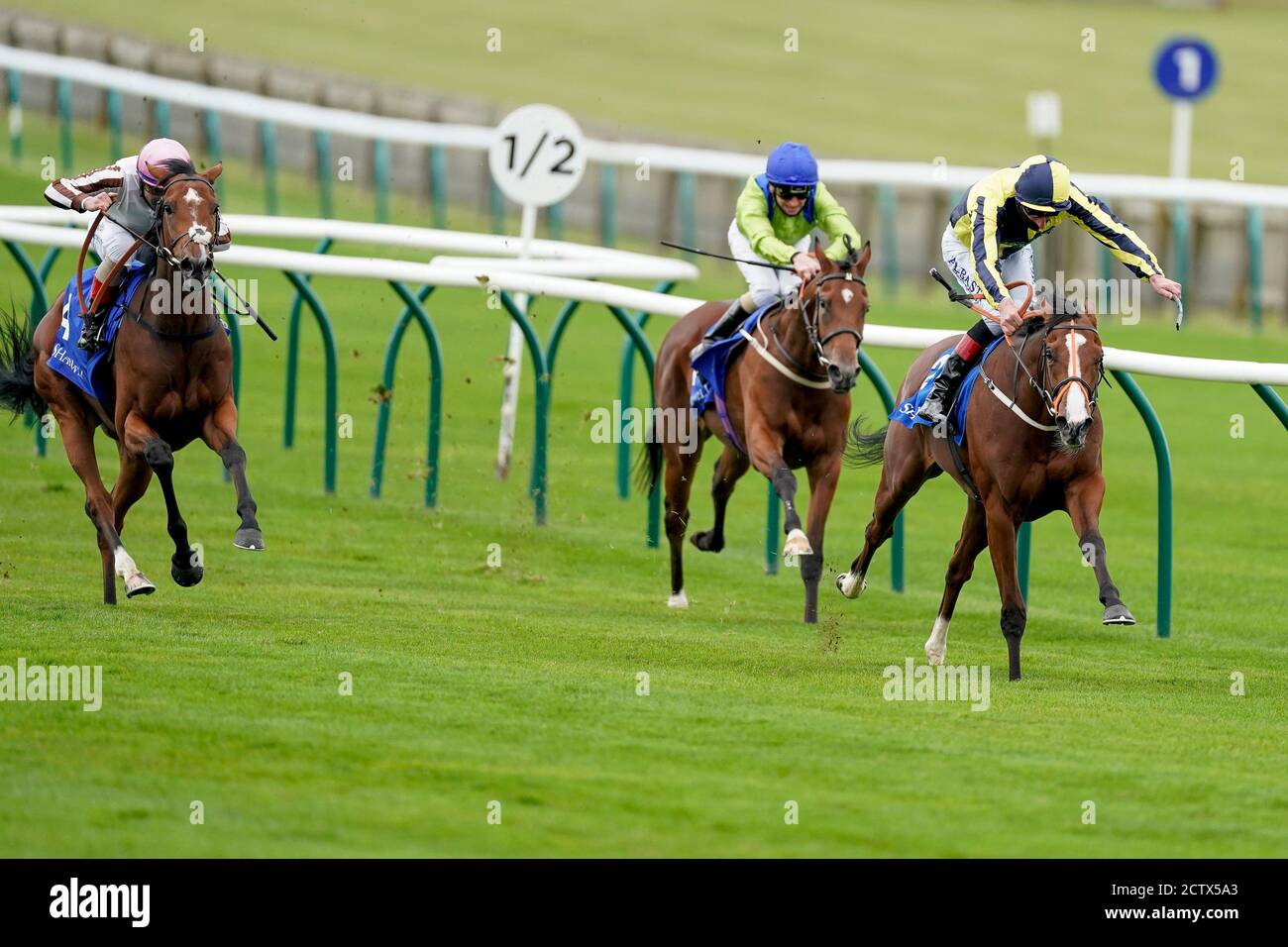 Isabella Giles ridden by Adam Kirby (right) win The Shadwell Rockfel Stakes during day two of The Cambridgeshire Meeting at Newmarket Racecourse. Stock Photo