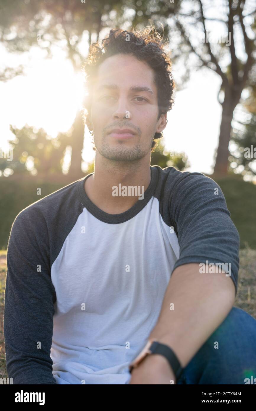 Portrait of young man in the park with beautiful sunset Stock Photo