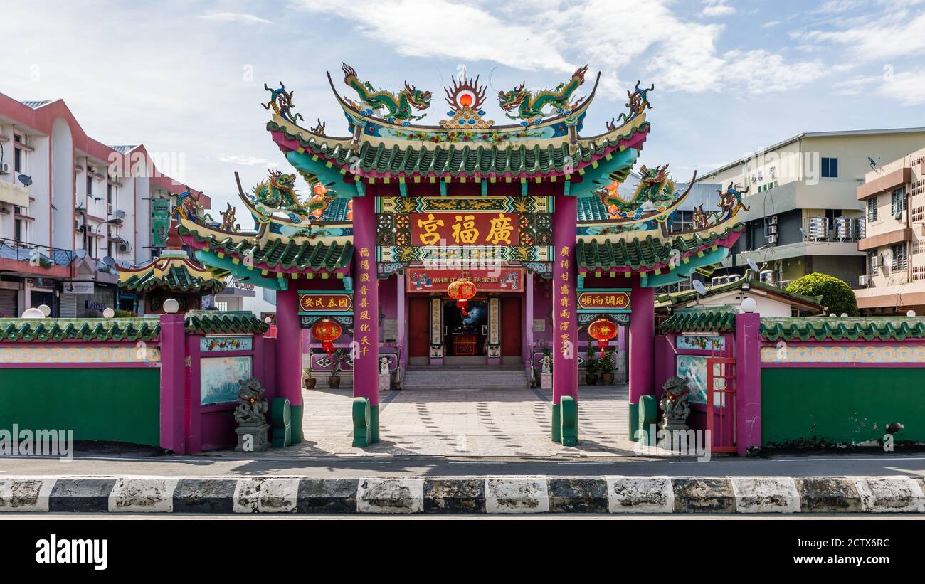 Labuan, Malaysia: Entrance gate of Kwang Fook Kong Temple in Old Town Labuan - decorated with chinese lanterns - seen from the temple Stock Photo