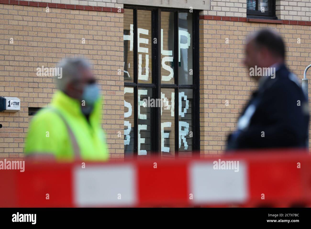 A sign saying 'help us, send beer' at Murano Street Student Village in Glasgow, where Glasgow University students are being tested at a pop up test centre. A range of new measures to combat the rise in coronavirus cases come into force in Scotland on Friday, including a ban on indoor household visits and a curfew for pubs and restaurants. Stock Photo