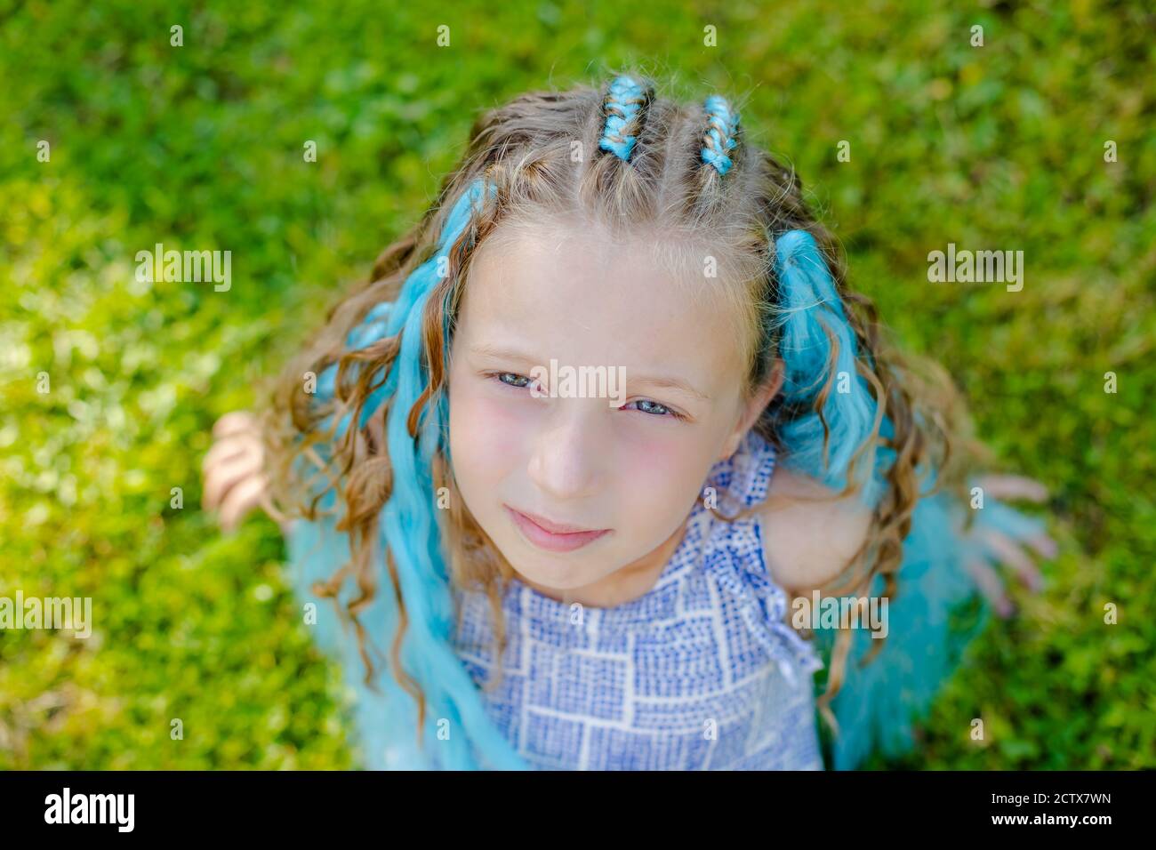 Portrait of beautiful girl with many braids with blue girl 7 years old with braids on green grass background. girl laying on a lawn Stock Photo - Alamy Portrait of beautiful girl with many braids with blue girl 7 years old with braids on green grass background. girl laying on a lawn Stock Photo - Alamy