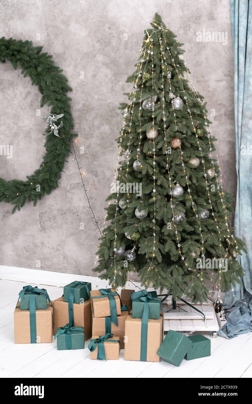 New Year's tree is decorated with garlands and balloons, under the tree ...
