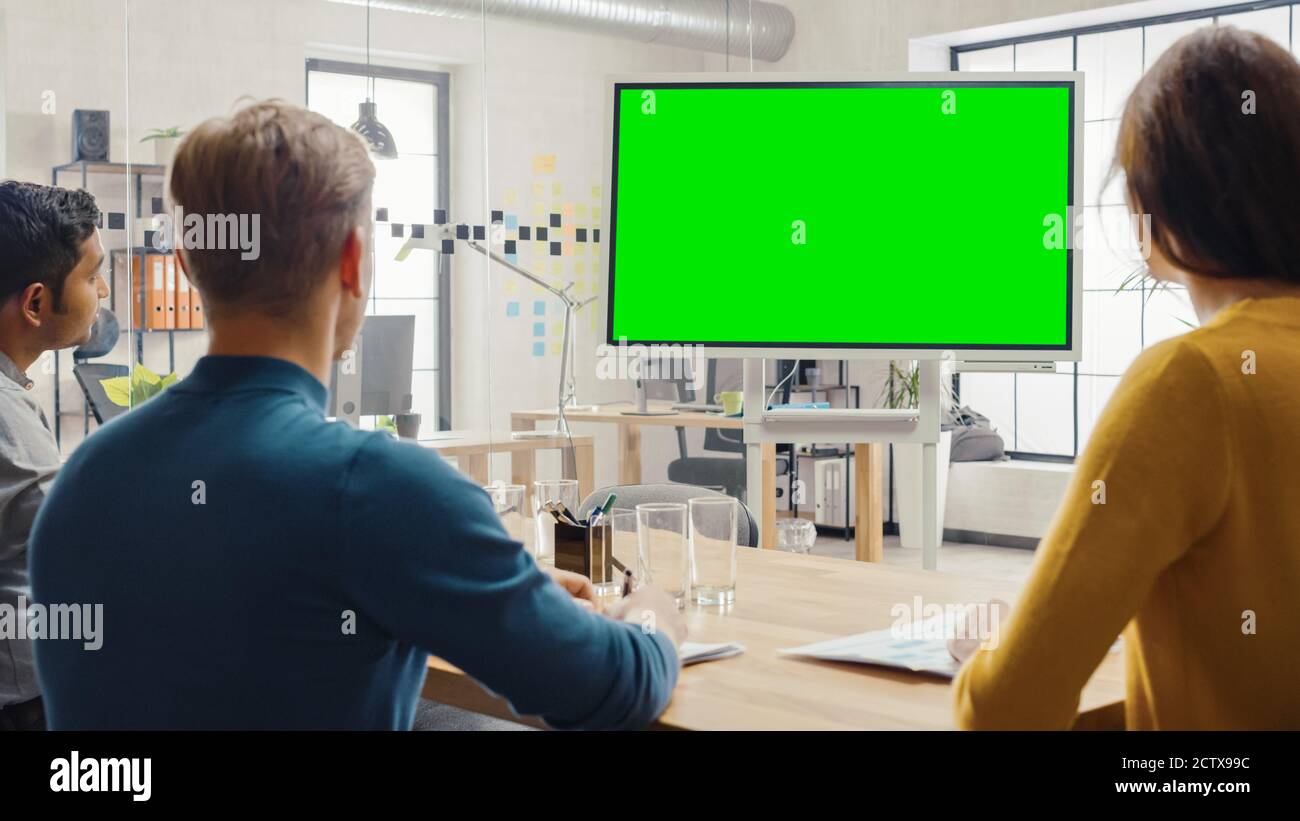 Team of Entrepreneurs Have a Meeting and Watch Green Screen Interactive  Whiteboard. Young People Work in Creative Office Stock Photo - Alamy