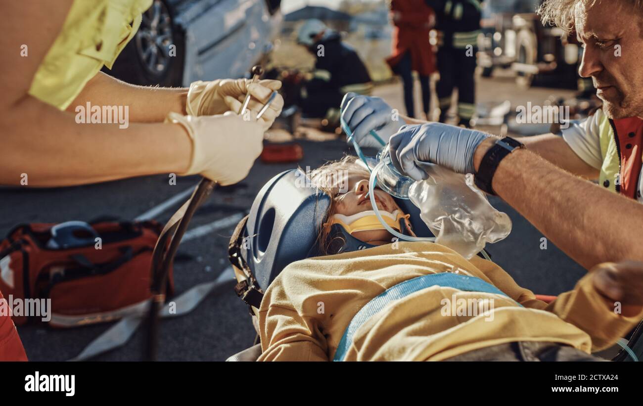 On the Car Crash Traffic Accident Scene Paramedics Saving Life of a